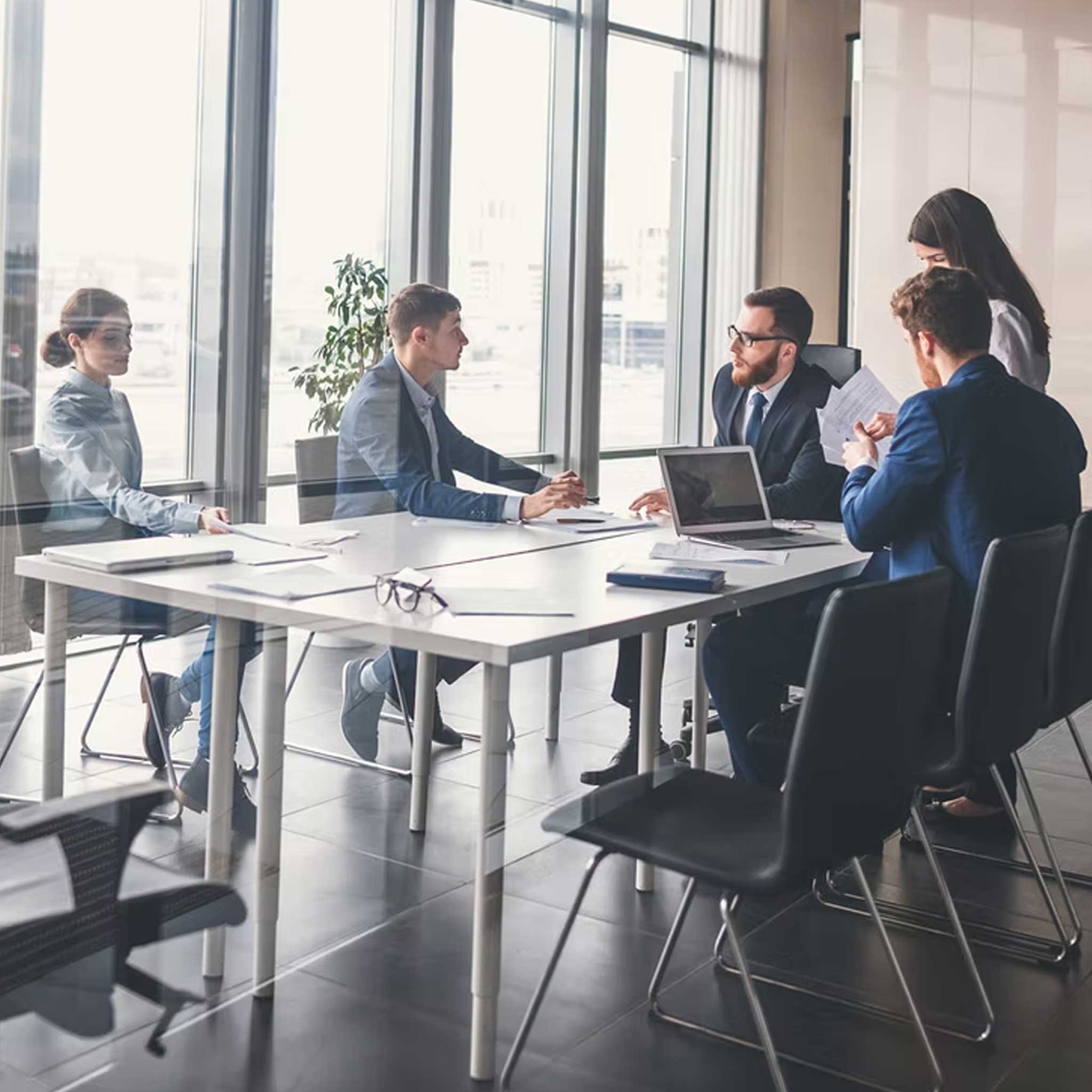 Group of professionals discussing in a meeting room.